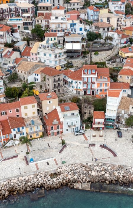 Parga, Greece. Aerial drone view of traditional Ionian coast city colorful facade buildings on the rocky hill, cloudy sky